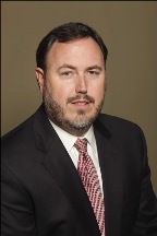 Corporate head-shot of Attorney H. E. Ellis Jr. partner at Staples, Ellis and Associates