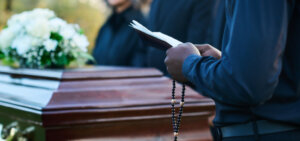 Person saying speech in front of casket