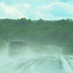 Cars hydroplaning on a highway.