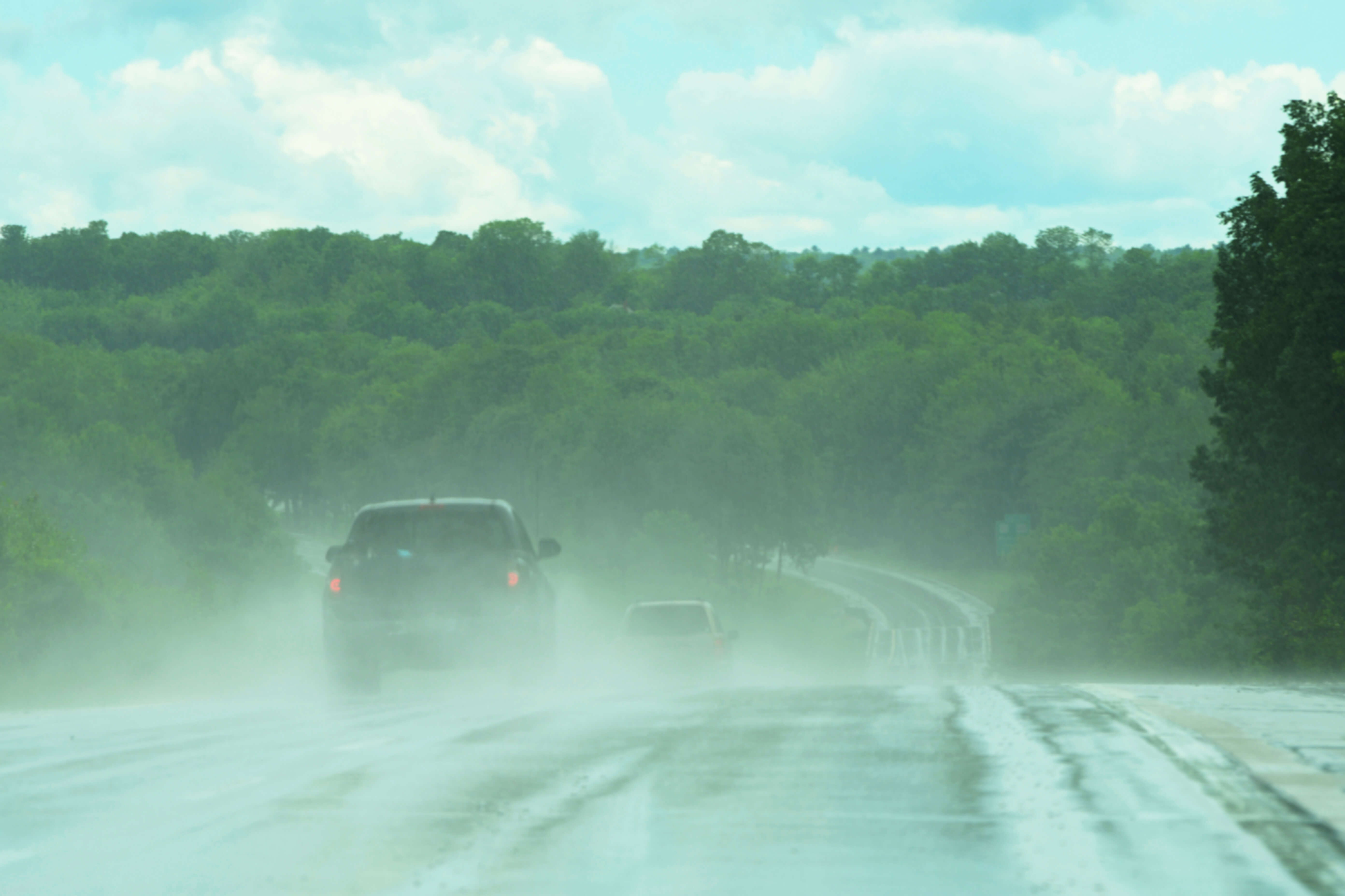 Cars hydroplaning on a highway.