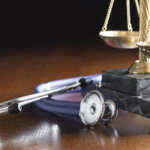 Stethoscope and scales of justice, medical malpractice.