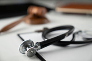 Stethoscope and gavel on top of medical malpractice.