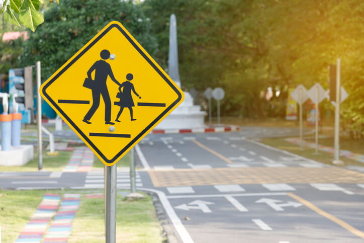 Students crossing ahead sign